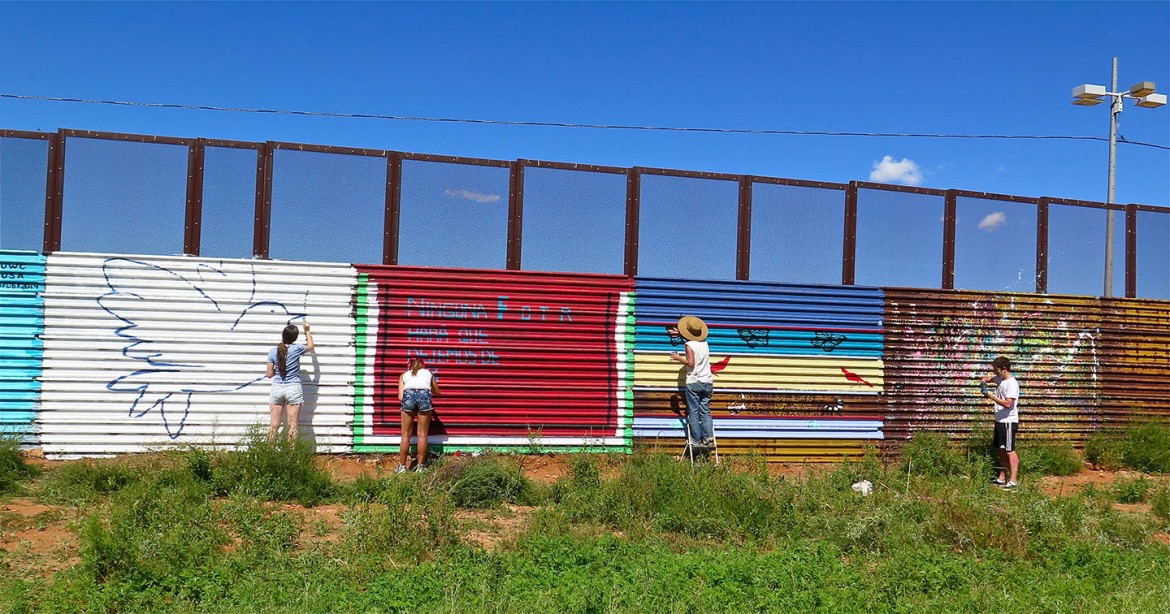 The Border Bedazzlers painting the Mexican side of the U.S.-Mexican border wall.  Photo by  Gretchen Baer