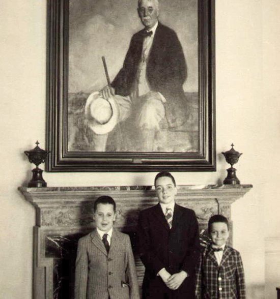 David Stanwood, right, at age 7, when his family visited Cuba, in front of a portrait of his great-grandfather Snare.